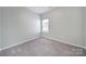 Neutral bedroom with carpet, a window, and painted in a light gray at 325 Ox Bow Cir, Mount Holly, NC 28120