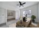 Bedroom with a ceiling fan and light, with the adjacent room visible through the glass French doors at 325 Ox Bow Cir, Mount Holly, NC 28120