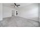 Neutral bedroom featuring a ceiling fan, two doorways, and plush carpeting at 325 Ox Bow Cir, Mount Holly, NC 28120