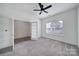 Bedroom with a ceiling fan and light, with the adjacent room visible through the glass French doors at 325 Ox Bow Cir, Mount Holly, NC 28120