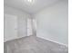 Bedroom with carpet, and doorway to a bathroom in a neutral color palette at 325 Ox Bow Cir, Mount Holly, NC 28120