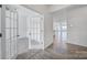 Bright entryway with wood floors that lead into a large living area, with a French door on the left at 325 Ox Bow Cir, Mount Holly, NC 28120