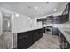 Beautiful kitchen features an island with granite countertop, dark cabinets, and stainless steel appliances at 325 Ox Bow Cir, Mount Holly, NC 28120