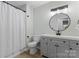 Bathroom featuring a shower/tub combo, toilet, and gray vanity with a round mirror and modern lighting fixture at 325 Spring Oak Dr, Salisbury, NC 28147