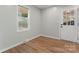 Empty bedroom with hardwood floors, light colored walls, and a door leading outside at 325 Spring Oak Dr, Salisbury, NC 28147