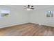 Well-lit bedroom with wood-look floors, ceiling fan, and large window at 325 Spring Oak Dr, Salisbury, NC 28147