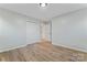 Bedroom featuring neutral walls, wood-look flooring, closet with sliding doors, and white trim at 325 Spring Oak Dr, Salisbury, NC 28147