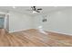 Empty bedroom with wood-look floors, light colored walls, a ceiling fan, and natural light from the window at 325 Spring Oak Dr, Salisbury, NC 28147