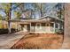 Charming single-story home with a covered carport, a front yard covered in leaves, and autumn foliage at 325 Spring Oak Dr, Salisbury, NC 28147