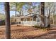 Charming single-story home nestled among mature trees, featuring a covered porch and inviting entrance at 325 Spring Oak Dr, Salisbury, NC 28147