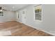 View of an empty living room with hard-wood flooring, large windows, and painted in a light color at 325 Spring Oak Dr, Salisbury, NC 28147