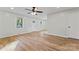 Bright living room with wood-look floors, ceiling fan, and natural light from windows at 325 Spring Oak Dr, Salisbury, NC 28147