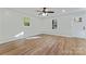 Bright living room with wood-look floors, ceiling fan, and natural light from windows at 325 Spring Oak Dr, Salisbury, NC 28147