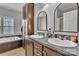 Bathroom features a double sink vanity, soaking tub, and tall wooden cabinet for ample storage space at 330 Chinquapin Ln, Mt Ulla, NC 28125