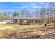 Charming single story home featuring black shutters, a covered deck, and spacious front yard at 330 Chinquapin Ln, Mt Ulla, NC 28125