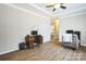 Bright office space with hardwood floors, a classic desk setup, and a glimpse of an adjacent bedroom at 330 Chinquapin Ln, Mt Ulla, NC 28125