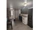 The eat-in kitchen provides black cabinets, white appliances and wood look floors at 348 Grice St, Shelby, NC 28150