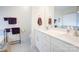 Elegant bathroom features double sinks, white cabinets, and a large mirror at 3941 Rothwood Ln, Harrisburg, NC 28075