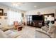 Cozy living room with a large window, plush seating, and elegant decor, perfect for relaxation and entertaining at 3941 Rothwood Ln, Harrisburg, NC 28075