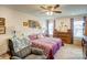 Bright main bedroom features a ceiling fan, lovely decorations, and large windows at 3941 Rothwood Ln, Harrisburg, NC 28075