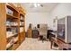 Spacious office with built-in shelving, a ceiling fan, and a dark wood desk at 3941 Rothwood Ln, Harrisburg, NC 28075