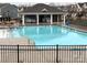 Community pool with chairs, tables, and covered picnic area at 3941 Rothwood Ln, Harrisburg, NC 28075