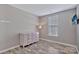 This spacious bedroom features light gray walls, wood floors, and bright, natural light at 4007 Hermes Ln, Waxhaw, NC 28173