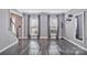 Grey painted open space with dark floors, large windows, and staircase visible at 4007 Hermes Ln, Waxhaw, NC 28173