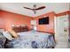 Stylish bedroom with a dark wood bed frame, mounted TV, and soft carpet, perfect for relaxation and entertainment at 405 Goldstaff Ln, Charlotte, NC 28273