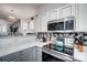 Sleek kitchen with stainless steel appliances, stylish backsplash, and seamless flow into the living space at 405 Goldstaff Ln, Charlotte, NC 28273