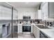 Modern kitchen featuring stainless steel appliances, white cabinets, and a sleek backsplash for stylish meal preparation at 405 Goldstaff Ln, Charlotte, NC 28273