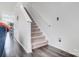 Carpeted staircase with white handrail and modern wood flooring creates an inviting and stylish transition between levels at 405 Goldstaff Ln, Charlotte, NC 28273