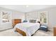 Bright bedroom featuring a queen bed, wood furniture, and natural light from two windows at 424 Virginia Ave, Statesville, NC 28677