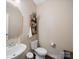 Powder room with pedestal sink, modern toilet and hardwood floors at 430 Battery Cir, Clover, SC 29710