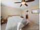 Bedroom with ceiling fan, carpet, and neutral paint; bathroom door visible at 430 Battery Cir, Clover, SC 29710