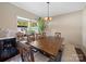 Bright dining room features wooden table, bench seating, and natural light from large windows at 430 Battery Cir, Clover, SC 29710