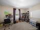 Cozy home office with natural light, carpet floors, and a bookcase for storage at 430 Battery Cir, Clover, SC 29710