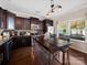 Stylish kitchen featuring dark cabinets, stainless steel appliances, and a central island table with barstool seating at 430 Battery Cir, Clover, SC 29710