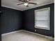 Comfortable bedroom featuring neutral carpet, trim, and a bright window at 4408 Pebblebrook Dr, Charlotte, NC 28208