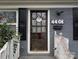 Close-up of the front door with a welcome wreath, set in a charming brick facade at 4408 Pebblebrook Dr, Charlotte, NC 28208