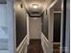 Inviting hallway with contrasting trim, fresh paint, and leading to multiple rooms at 4408 Pebblebrook Dr, Charlotte, NC 28208