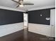 Spacious living area featuring modern trim, dark walls, and hardwood flooring at 4408 Pebblebrook Dr, Charlotte, NC 28208