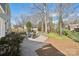 Wide backyard features mature trees, green lawn, brick patio, and fence at 4811 Dawnridge Dr, Charlotte, NC 28226