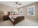 Cozy bedroom with two bright windows, bedside tables, and stylish decor at 4811 Dawnridge Dr, Charlotte, NC 28226