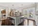 Kitchen island with seating, granite counters, and french doors leading to the outdoor living space at 4811 Dawnridge Dr, Charlotte, NC 28226