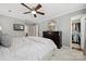 Spacious main bedroom with gray walls, walk-in closet, and ceiling fan at 4811 Dawnridge Dr, Charlotte, NC 28226