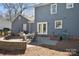 Backyard patio features stone pavers, a brick wall, and patio furniture at 4811 Dawnridge Dr, Charlotte, NC 28226