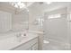 Bright bathroom featuring a white vanity, framed mirror, shower, and tub with white tile surround at 4918 Sarah Hall Ln, Charlotte, NC 28270