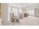 Spacious bedroom with lots of natural light, a coffered ceiling, neutral walls, and an area for seating and dressers at 4918 Sarah Hall Ln, Charlotte, NC 28270