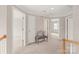 Upstairs hallway featuring carpet, a small sitting area, and doors leading to additional rooms in the home at 4918 Sarah Hall Ln, Charlotte, NC 28270